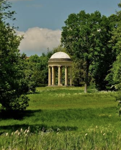 Classical garden temple surrounded by green landscape